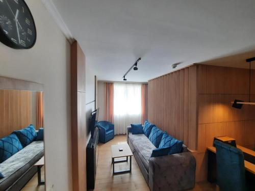 a living room with a couch and a tv at Apartman Radmila in Kopaonik