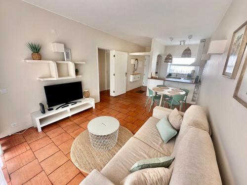 a living room with a couch and a table at Solar Home appartement T2 in Albufeira