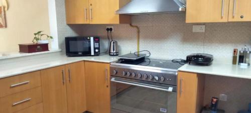 a kitchen with a stove and a microwave at Full sea view Studio high floor in Ras al Khaimah