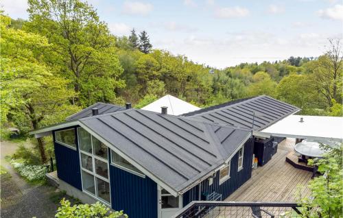 an overhead view of a blue house with a deck at Three-Bedroom Holiday Home In Spottrup in Lihme
