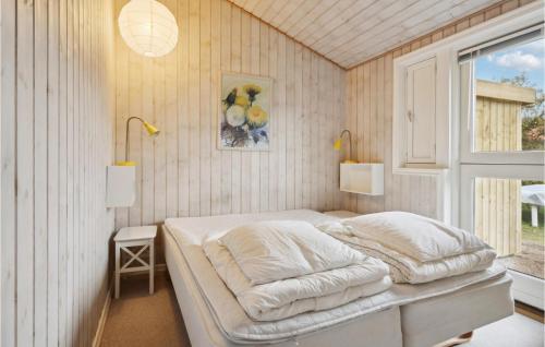 a bedroom with a bed in a room with a window at 3 Bedroom Amazing Home In Nyborg in Nyborg