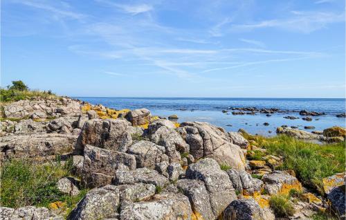 a pile of rocks on a beach near the ocean at 1 Bedroom Nice Apartment In Svaneke in Svaneke