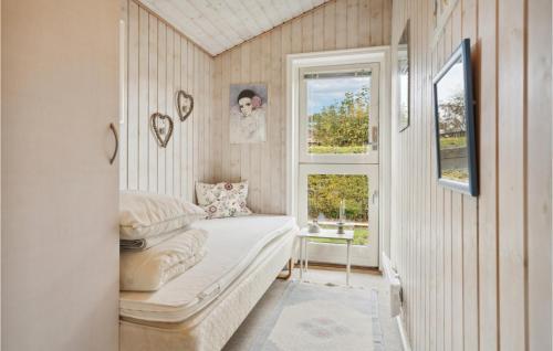 a small bedroom with a bed and a window at 3 Bedroom Amazing Home In Nyborg in Nyborg