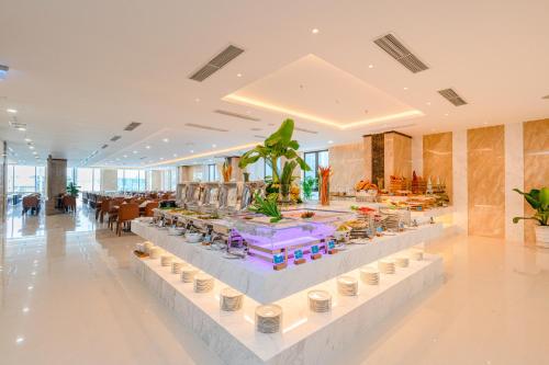 a lobby with a table with food on it at Gonsala Hotel Nha Trang in Nha Trang