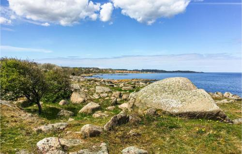 a group of rocks on a hill next to the water at Lovely Apartment In Svaneke With Wifi in Svaneke
