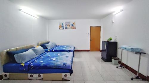 a bedroom with a bed and a television in it at Apartment near Central Festival Hatyai in Hat Yai
