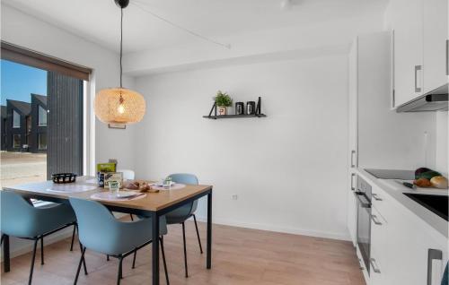 a dining room with a table and chairs in a kitchen at Havnehusene, Lejl 45 in Slagelse