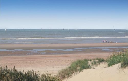 a group of people standing on a beach near the ocean at 3 Bedroom Awesome Home In Oostduinkerke in Oostduinkerke