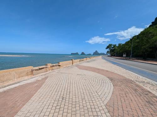 a cobblestone road next to the ocean at House Of Jade in Prachuap Khiri Khan