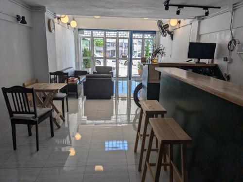 a bar with wooden chairs and tables in a restaurant at House Of Jade in Prachuap Khiri Khan