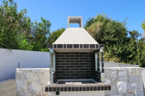 a brick oven sitting on top of a wall at Villa Paradisio - Pool, Sea View, 4bdrms,BBQ in Hanioti