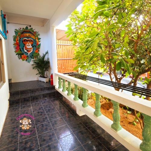 a room with a tree and a painting on the wall at The Funky Monkey Hostel - 18 to 40 years old only in Haad Rin