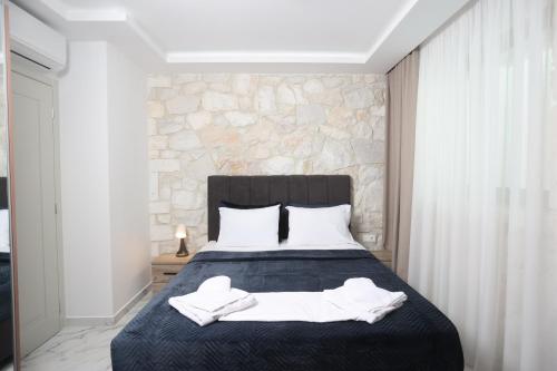 a bedroom with a bed with white towels on it at Villa Paradisio - Pool, Sea View, 4bdrms,BBQ in Hanioti