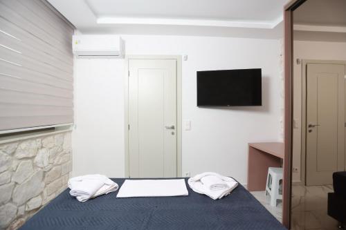 a bedroom with a bed with two towels on it at Villa Paradisio - Pool, Sea View, 4bdrms,BBQ in Hanioti