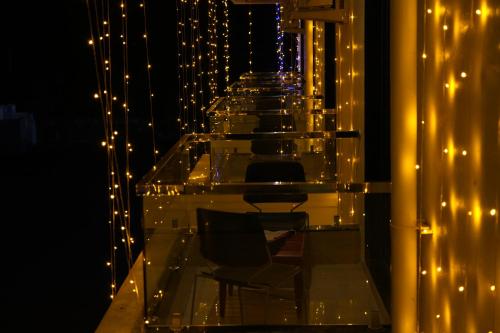 a row of chairs on a balcony with lights at SKD RESORT AND CLUB in Barvāla