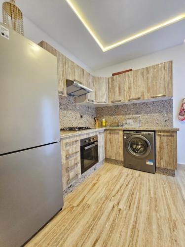 a kitchen with a refrigerator and a dishwasher at MIA Appartement N2 - Élégance, Confort et Sérénité in Casablanca