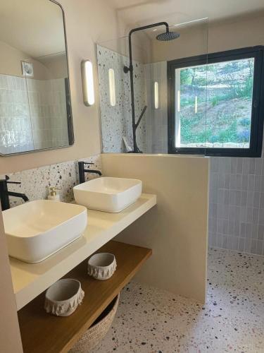 a bathroom with a sink and a mirror at La canopée, Bastide sur les hauteurs de Lourmarin in Lourmarin