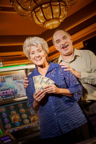 a man standing next to a woman holding money at Pahrump Nugget Hotel & Casino in Pahrump