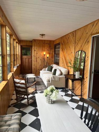 a living room with a couch and a table at 4Bdrm Muskoka Retreat, Fire Table, Games, Netflix in Port Carling