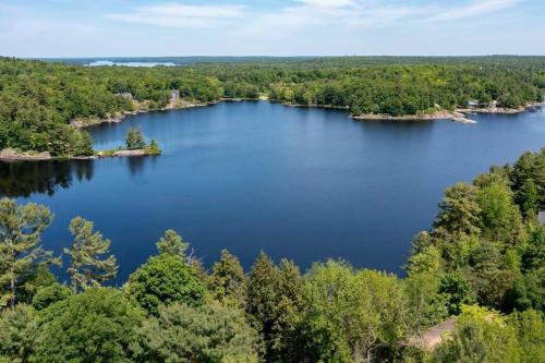 an aerial view of a lake with trees at 4Bdrm Muskoka Retreat, Fire Table, Games, Netflix in Port Carling