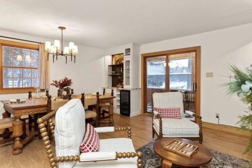 a living room with a table and a dining room at 4Bdrm Muskoka Retreat, Fire Table, Games, Netflix in Port Carling