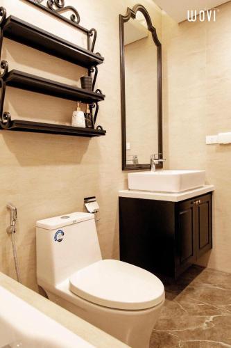 a bathroom with a toilet and a sink and a mirror at Apec Boutique Hotel Phú Yên in Tuy Hoa