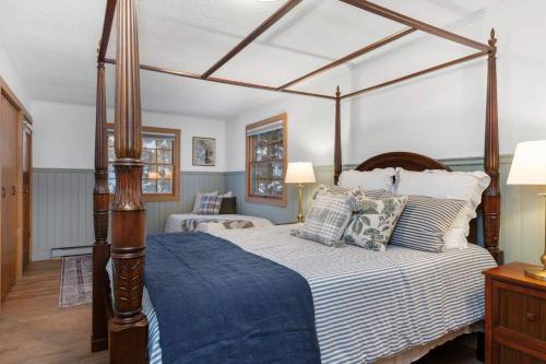 a bedroom with a large canopy bed with pillows at 4Bdrm Muskoka Retreat, Fire Table, Games, Netflix in Port Carling