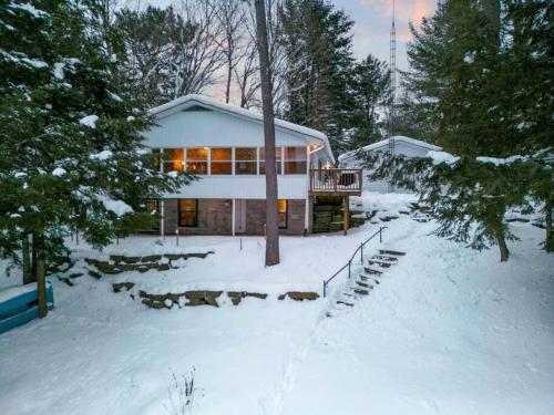 a house in the snow with a snow covered yard at 4Bdrm Muskoka Retreat, Fire Table, Games, Netflix in Port Carling
