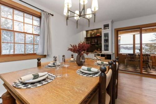 a kitchen and dining room with a wooden table and chairs at 4Bdrm Muskoka Retreat, Fire Table, Games, Netflix in Port Carling