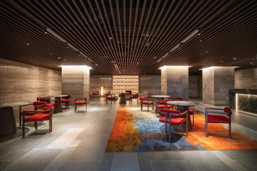 a lobby with tables and chairs and a fireplace at Apec Boutique Hotel Phú Yên in Tuy Hoa