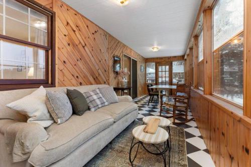 a living room with a couch and a table at 4Bdrm Muskoka Retreat, Fire Table, Games, Netflix in Port Carling