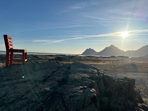 a chair sitting on a rock in the desert at Lodge Borgarbrekka in Lón South East of Iceland - Birta Rentals in Höfn