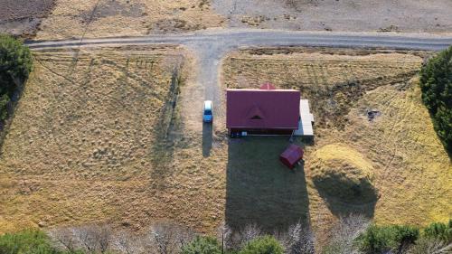an aerial view of a barn in a field at Lodge Borgarbrekka in Lón South East of Iceland - Birta Rentals in Höfn