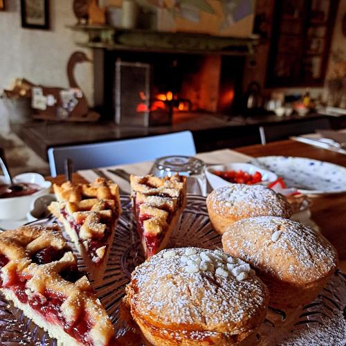 a table topped with pastries and waffles and a plate of food at Casadesergio in Refrontolo