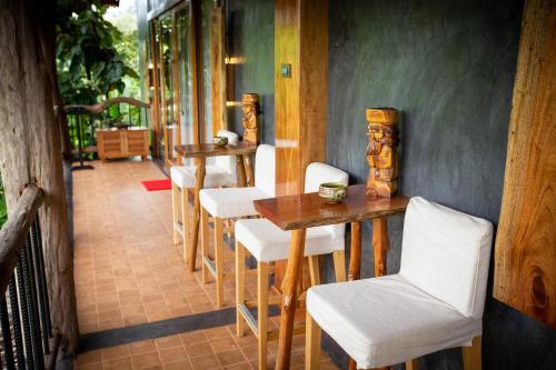 a dining room with white chairs and a table at Andalay Beach Resort Koh Libong in Ko Libong