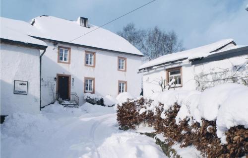 a house covered in snow next to a building at Haus Marx in Dürler