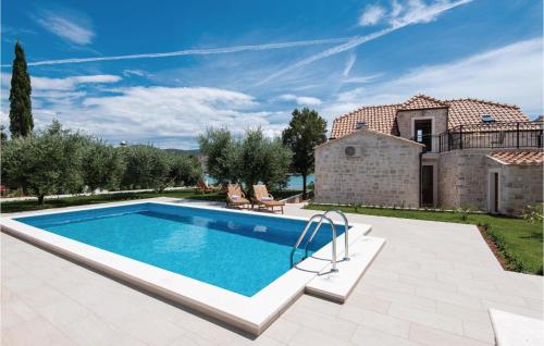 an image of a swimming pool in front of a house at Three-Bedroom Holiday Home In Loviste in Lovište