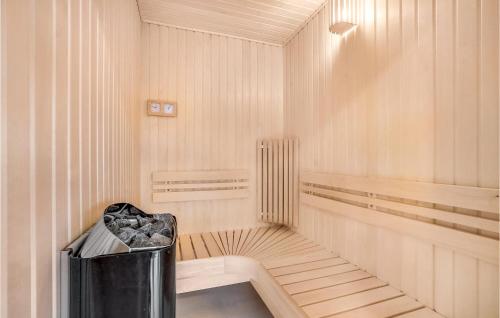 an empty sauna with a trash can in the middle at Lovely Home In Løgstrup With Wifi in Løgstrup