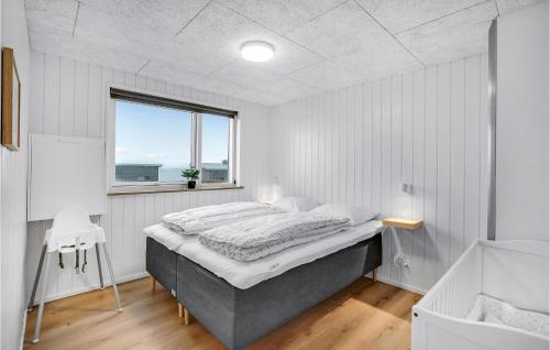 a bedroom with a large bed and a window at Lovely Home In Løgstrup With Wifi in Løgstrup