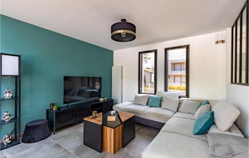 a living room with a couch and a tv at Cozy Home In Stjean De Monts in Saint-Jean-de-Monts