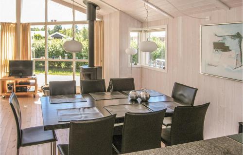 a dining room with a table and chairs at Holiday Home Enebærvænget Humble Ii in Nyby
