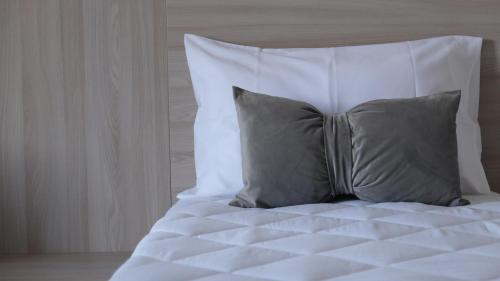 a white bed with two pillows on top of it at B&B Bella Peschici in Peschici