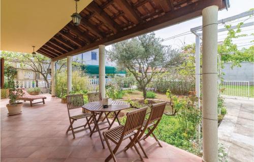 a patio with a table and chairs on a patio at Holiday Home Put Vrljuge Iv in Sukošan
