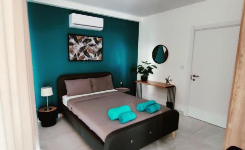 a bedroom with a large bed with blue walls at Seaview Three-O-Two in St. Paul's Bay