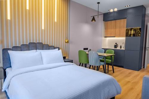 a bedroom with a bed and a table and chairs at New Gudauri Neo Apartments in Gudauri
