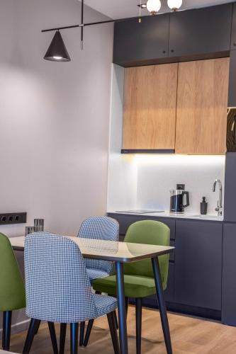a kitchen with a table and four chairs at New Gudauri Neo Apartments in Gudauri
