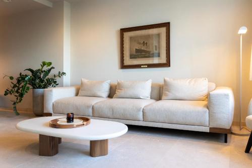 a living room with a couch and a coffee table at Unieke villa Catherine met frontaal zeezicht, parking sauna en strandcabine in De Panne