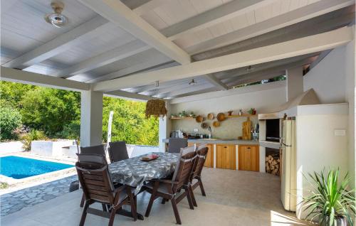 a kitchen and dining room with a table and chairs at Cozy Home In Malinska With Wifi in Malinska