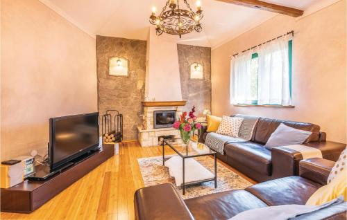 a living room with a couch and a tv at Cozy Home In Malinska With Wifi in Malinska