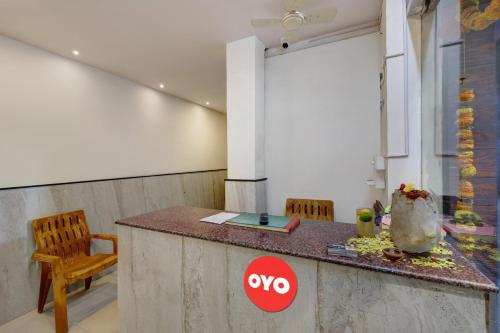 a kitchen with a counter and a table and chairs at Hotel O Millennia in Visakhapatnam